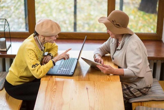 Two senior women and laptop. Should Seniors Use Social Media