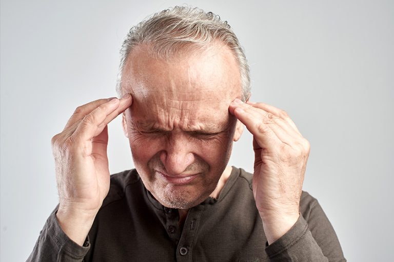 An old man touches his head. Headache. Alzheimer’s disease An old man touches his head. Headache. Alzheimer's disease
