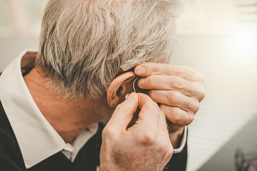 Man putting hearing aids