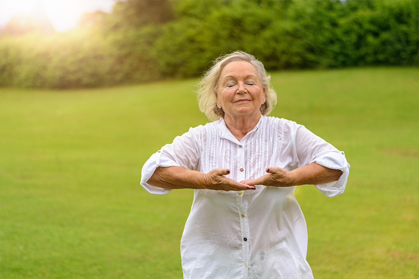 Woman with eyes closed doing breathing exercises Woman with eyes closed doing breathing exercises