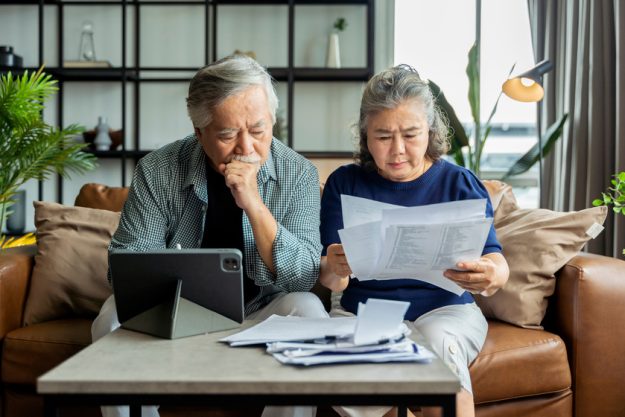 old retired asian senior couple checking and calculate financial old retired asian senior couple checking and calculate financial