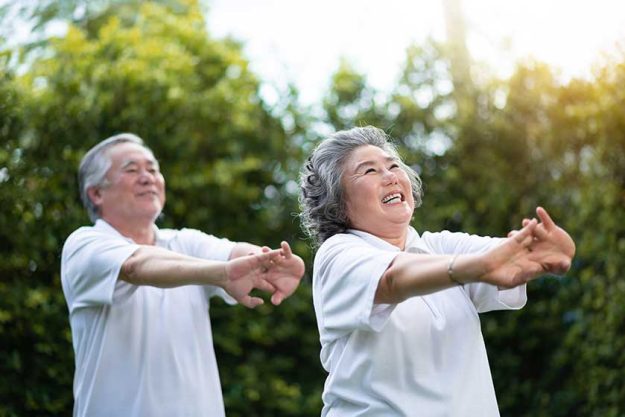 Happy Asian senior couple exercise.
