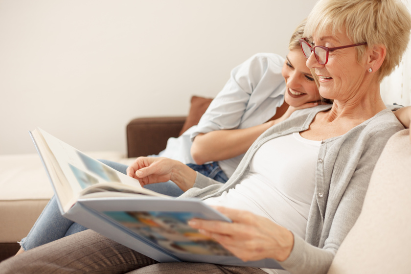 Mother and daughter having a great time while looking through ol How Are Your Aging Parent's Needs Met In Memory Care?
