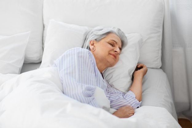 senior woman sleeping in bed at home bedroom