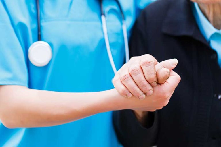 Caring Nurse holding Elderly Hands Caring Nurse holding Elderly Hands