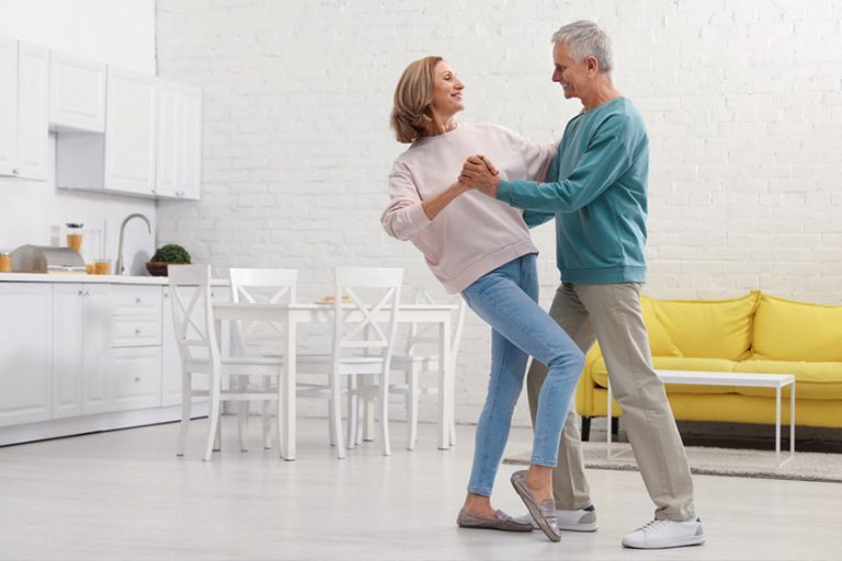 Energetic senior family couple dancing together