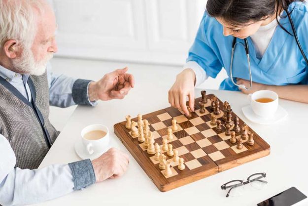 High angle view of nurse with senior man sitting
