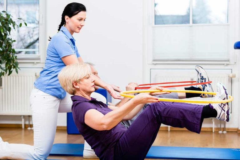 Senior couple in physiotherapy doing exercise