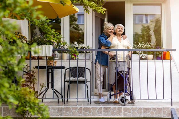 Senior Woman Her Adult Daughter Standing Balcony