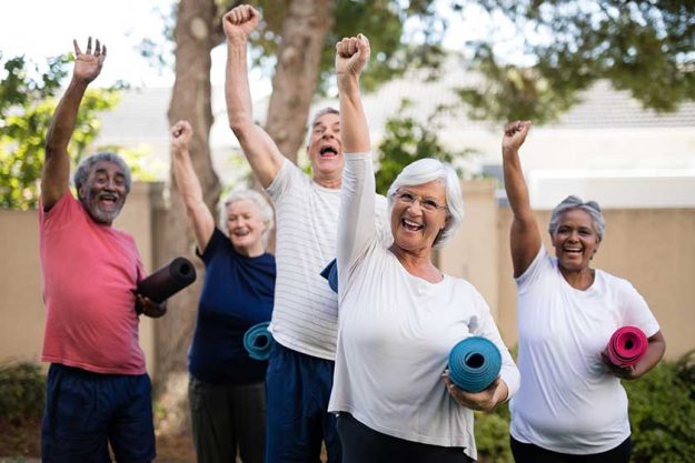 Seniors with exercise mats at park