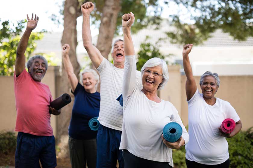 Seniors with exercise mats at park Seniors with exercise mats at park