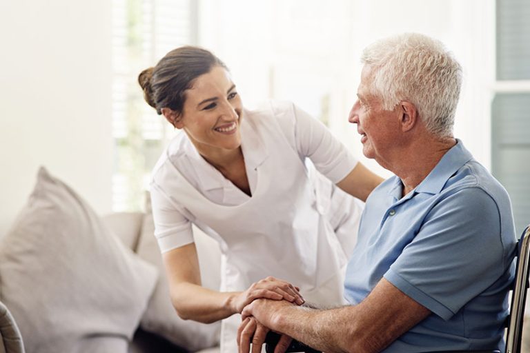 Shot of a caregiver helping a senior man in a wheelchair