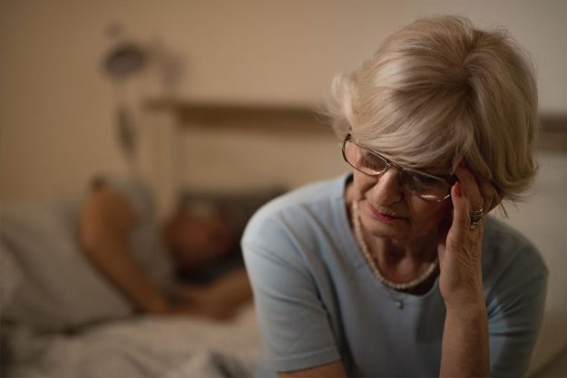 Mature Woman Holding Her Head in Pain