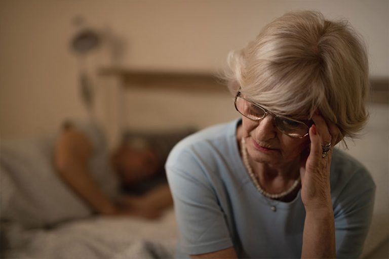 Mature Woman Holding Her Head in Pain