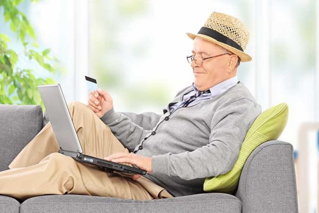 Senior with laptop and credit card