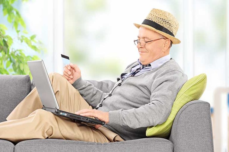 Senior with laptop and credit card Senior with laptop and credit card