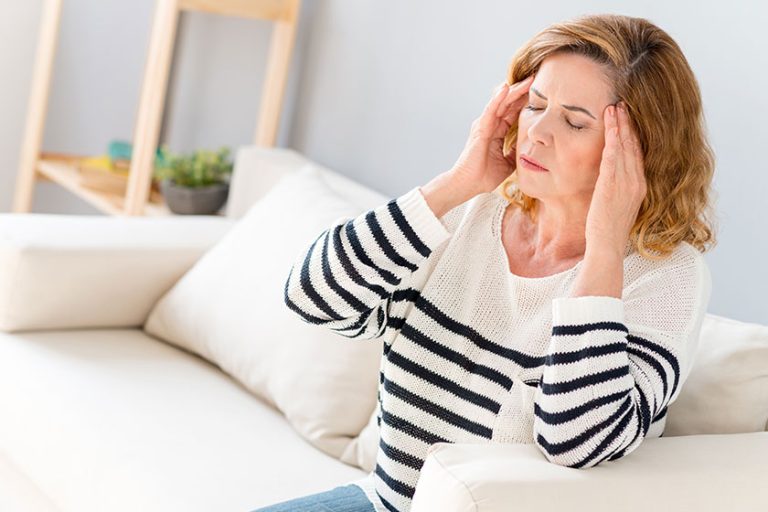 Senior woman feels pain in head Senior woman feels pain in head