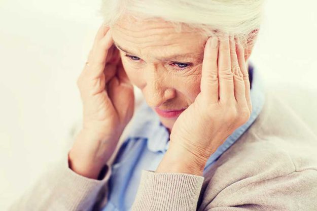 Face of senior woman suffering from headache