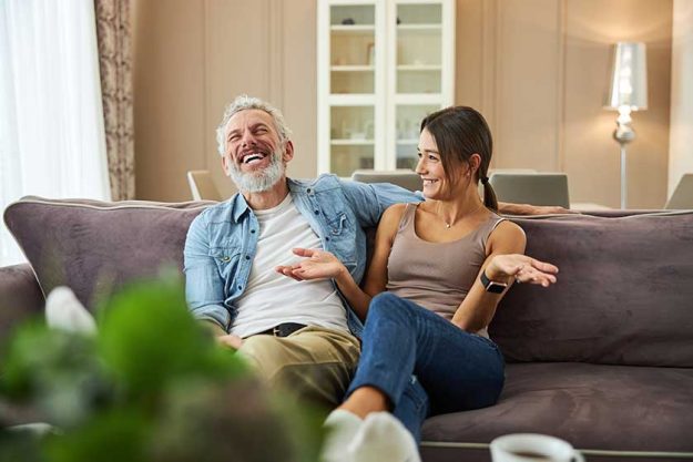Positive delighted bearded man laughing at joke