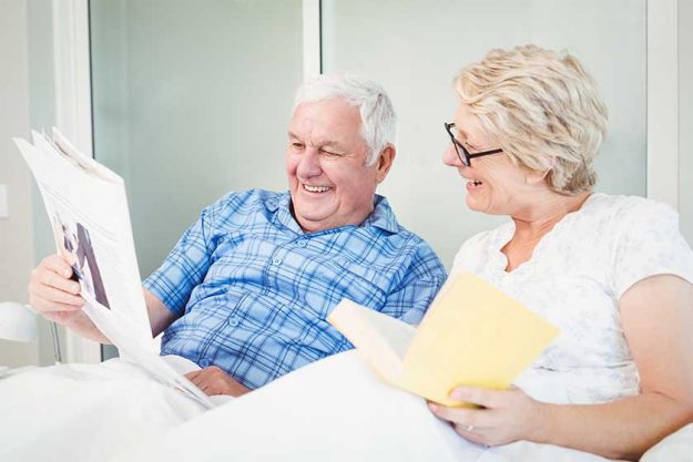 Senior couple reading newspaper