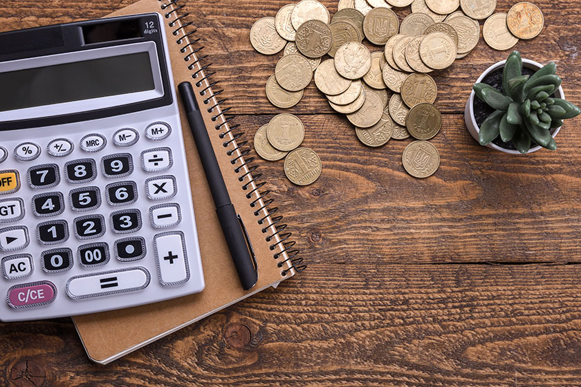Calculator keypad,gold coins, pen and notebook Calculator keypad,gold coins, pen and notebook