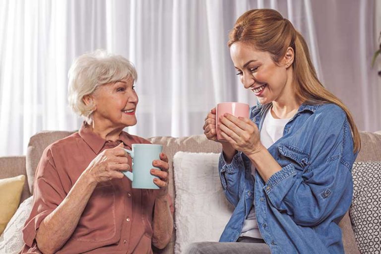 Outgoing grandma and woman drinking beverage Outgoing grandma and woman drinking beverage