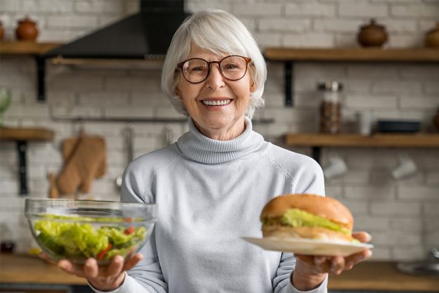 Healthy food concept. Mature smiling woman