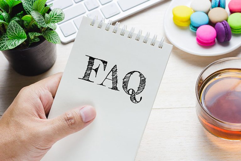 Man holding FAQ message on book