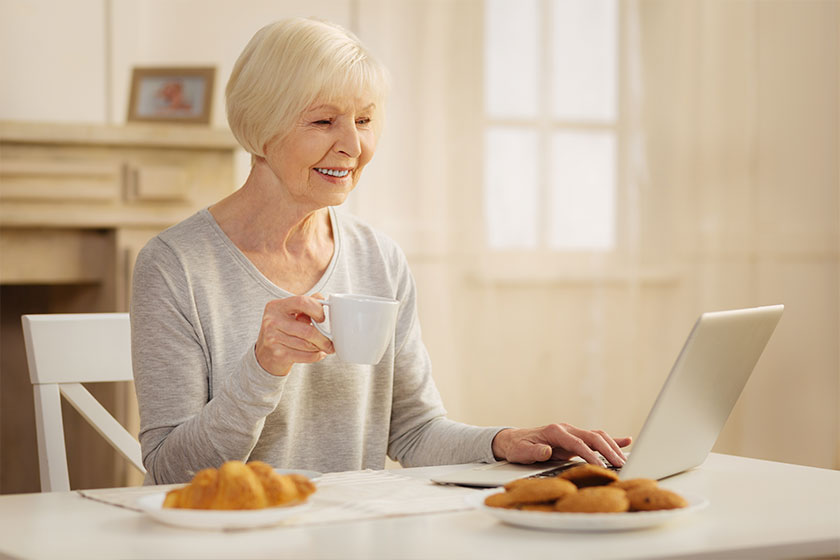 Pretty blonde looking at screen of her computer