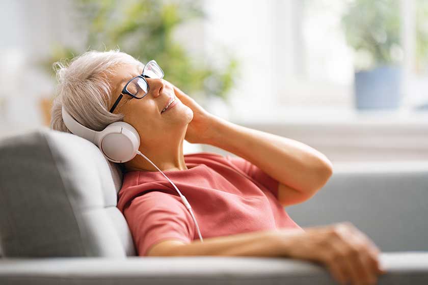 Senior woman listening to music in headphones