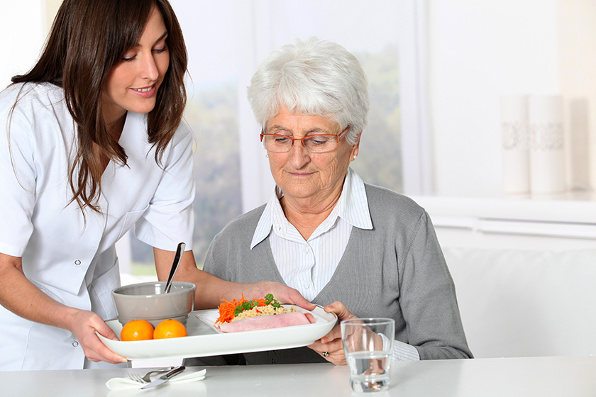 Beautiful nurse bringing meal tray Beautiful nurse bringing meal tray