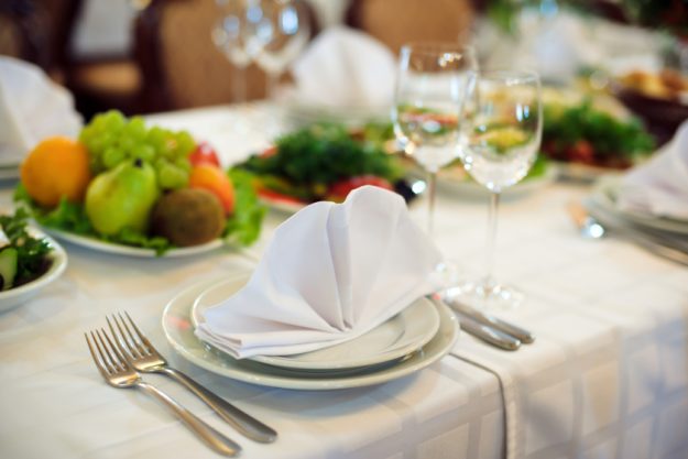 Catering service. Restaurant table with food. Huge amount of on the . Plates . Dinner time. Catering service. Restaurant table with food. Huge amount of on the . Plates . Dinner time.