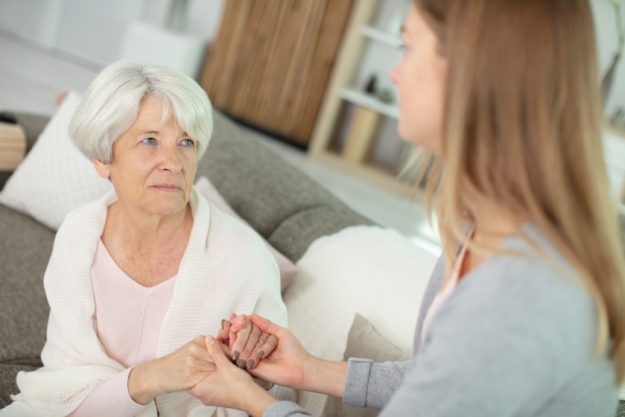 senior sad woman talking to her daughter