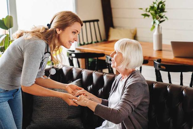 Caring daughter comforting frustrated unhappy senior woman. Loving adult granddaughter talking to sad depressed old grandmother holding hand and comforting her. Upset widowed woman with headache consoled by her daughter Caring daughter comforting frustrated unhappy senior woman. Loving adult granddaughter talking to sad depressed old grandmother holding hand and comforting her. Upset widowed woman with headache consoled by her daughter