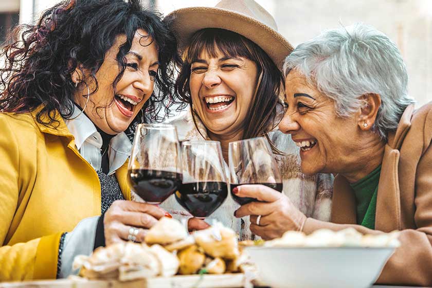 Mature people having fun hanging out on city street. Life style concept with older friends smiling and laughing together Mature people having fun hanging out on city street. Life style concept with older friends smiling and laughing together