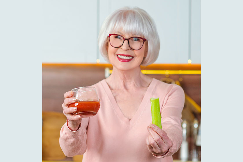 Senior cheerful woman with celery and tomato juice diet Senior cheerful woman with celery and tomato juice diet