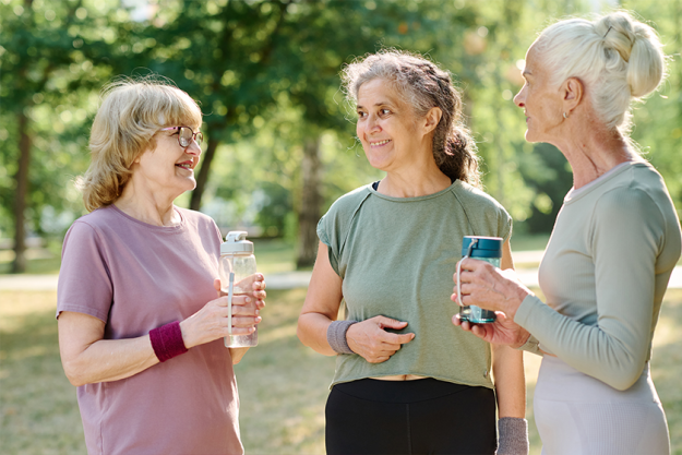 Senior women drinking water and talking to each other