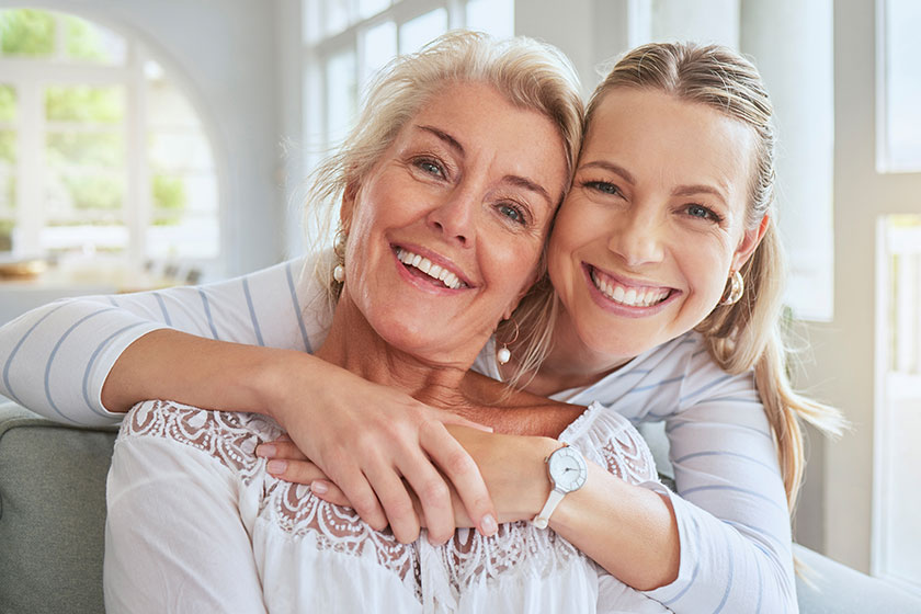 Women hug family bond mothers day house living room