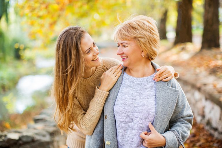 Mother and adult daughter outdoor in park. Mother and adult daughter outdoor in park.