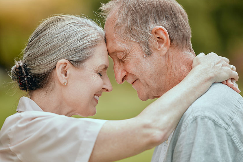 Elderly couple forehead touch love care bonding retirement outdoor Elderly couple forehead touch love care bonding retirement outdoor