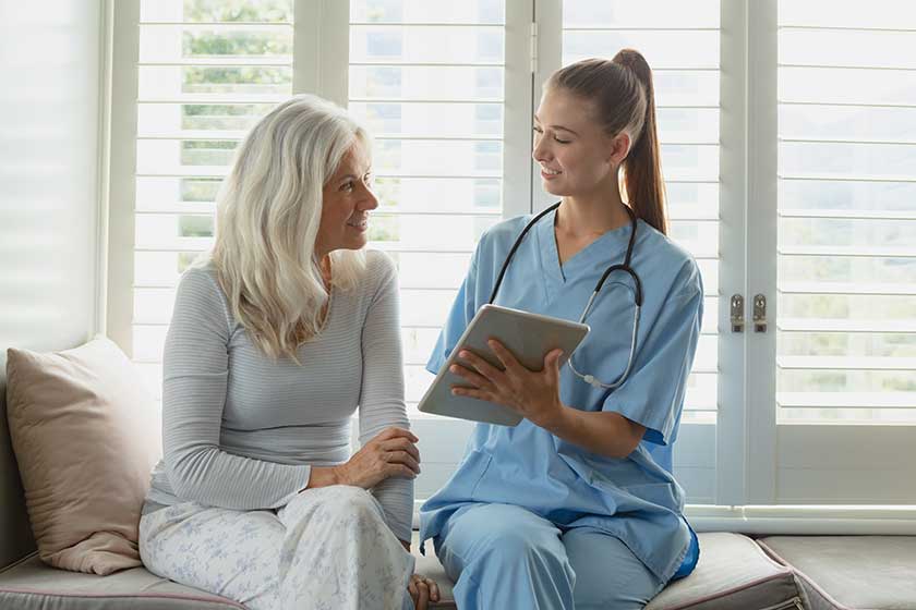 front view active senior caucasian woman female doctor using digital