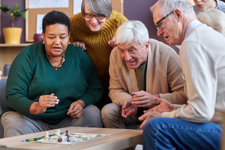 group senior people playing board games together retirement home emotional group senior people playing board games together retirement home emotional