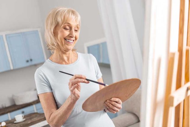 happy mature woman mixing colors