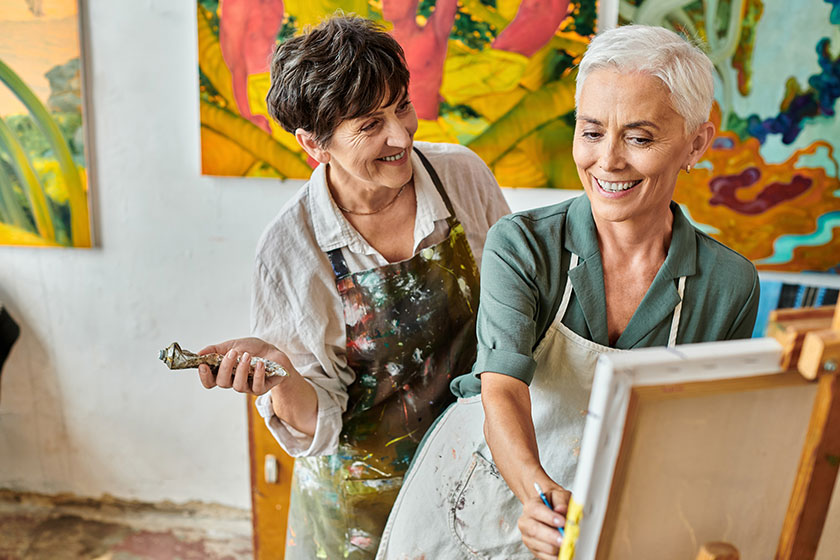 happy middle aged woman painting easel skillful female artist maste