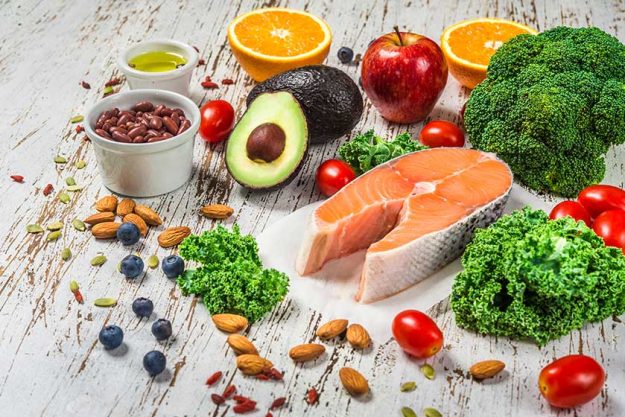 selection of fresh fruit and vegetables salmon beans and nuts