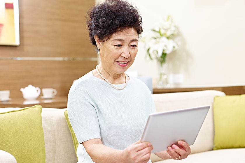 senior asian woman using tablet computer