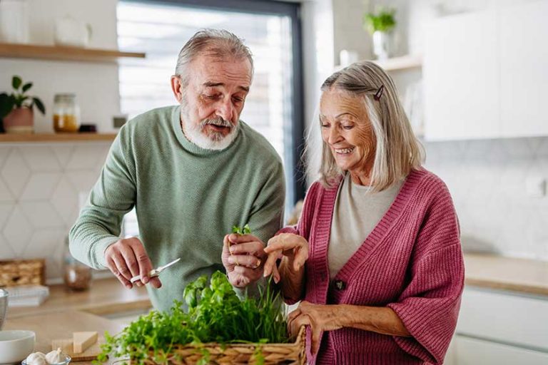 senior couple smelling fresh herbs cooking kitchen senior couple smelling fresh herbs cooking kitchen