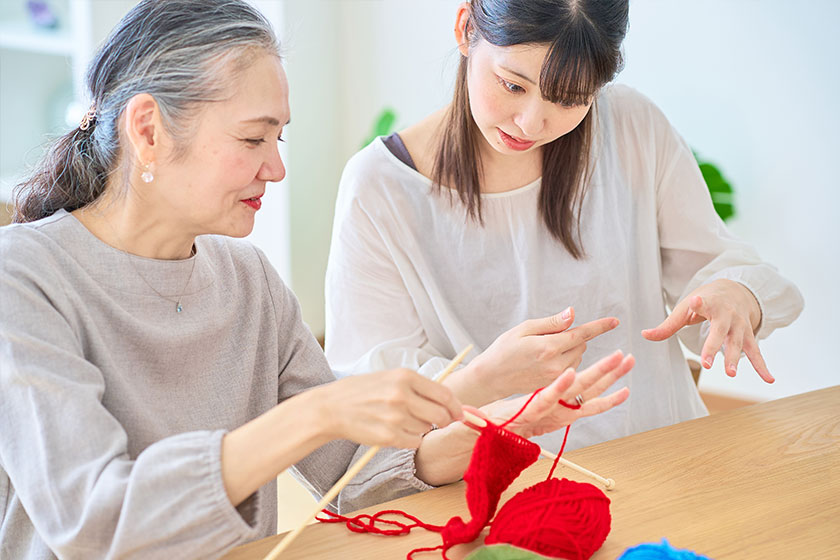 Senior woman and young woman knitting Senior woman and young woman knitting