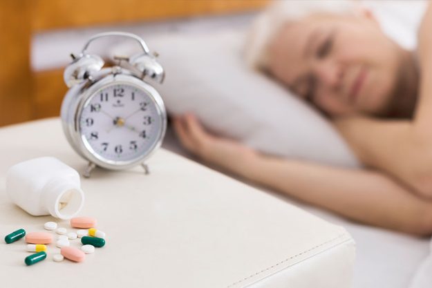 Senior woman sleeping in bed with help of pills Senior woman sleeping in bed with help of pills