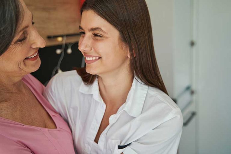 smiling female person celebrating date of birth of elderly friend smiling female person celebrating date of birth of elderly friend
